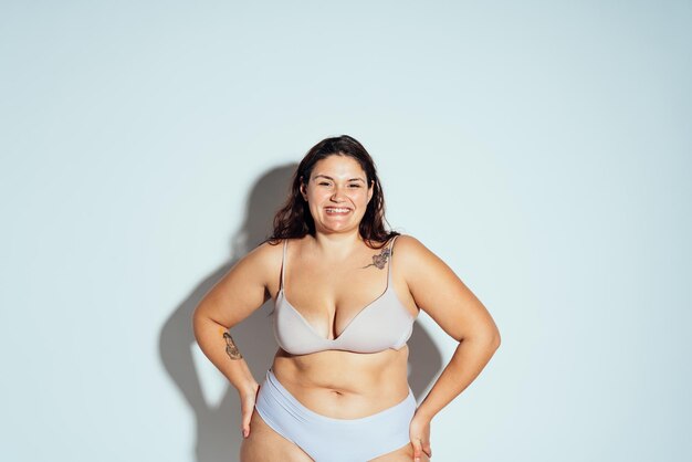Plus size woman posing in studio in lingerie