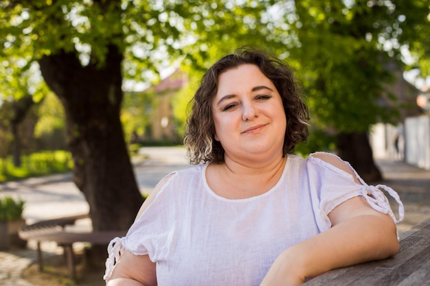 Plus size woman relaxing at outdoors cafe