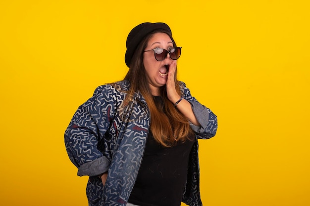 Plus size woman in stylish clothes in studio photos with facial expressions