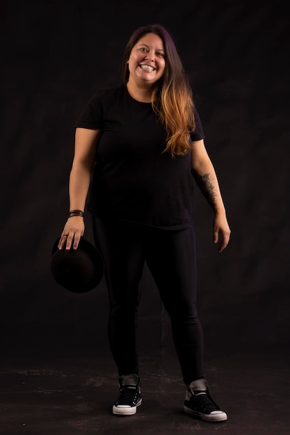 Plus size woman in stylish clothes in studio photos with facial expressions