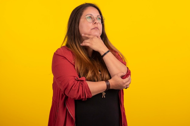 Plus size woman in stylish clothes in studio photos with facial expressions