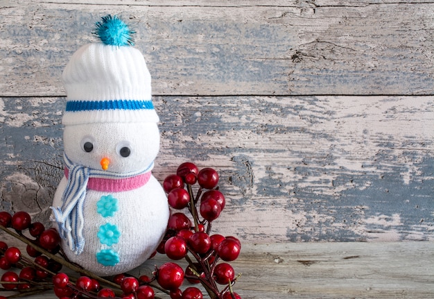 Plushie snowman with a cranberry stick