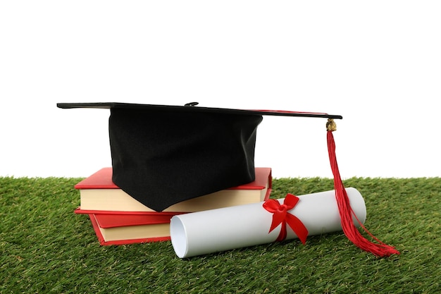 PNG graduate hat with books on grass isolated on white background