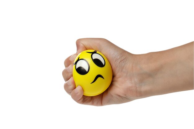 Photo png yellow ball smiley clenched in hand isolated on white background