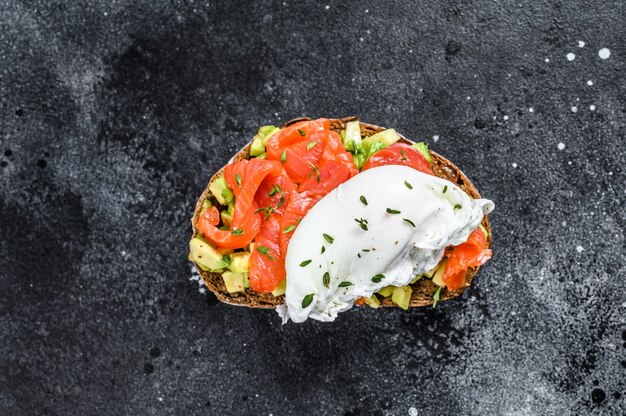 Poached egg on grilled toast with smoked salmon and avocado