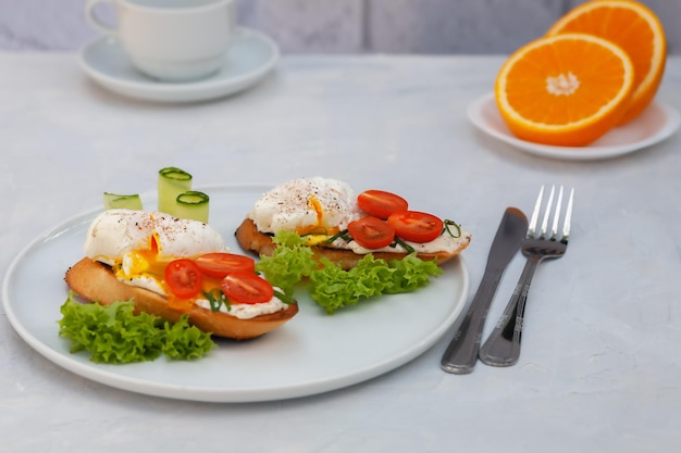 Poached egg toast with tomato and cream cheese and bread on a plate healthy food concept