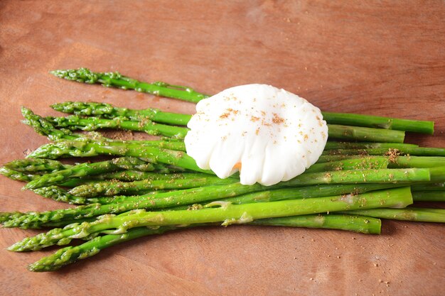 Poached egg with fried asparagus.  Healthy French breakfast concept