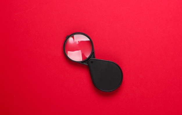 Pocket magnifier on red.