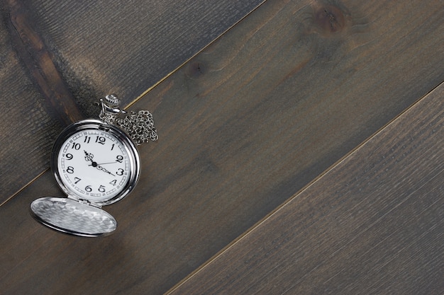 Photo pocket watch on wooden table