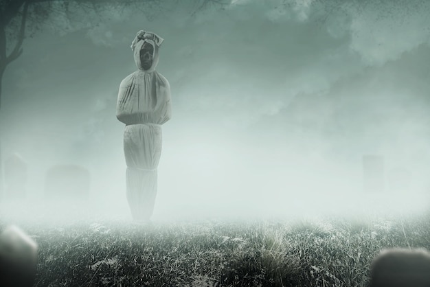 Photo pocong is covered with a white linen shroud standing