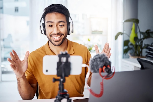 Podcast happy and live streaming with a man content creator recording a broadcast in his home office Internet freelance and subscription with a male vlogger or creator working in his studio