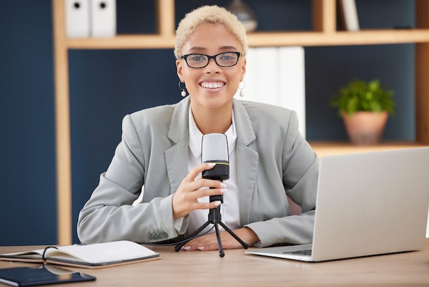 Podcast radio or broadcast with a black woman working on a laptop in her office for live streaming or content Influencer microphone and studio with a female presenter broadcasting from work