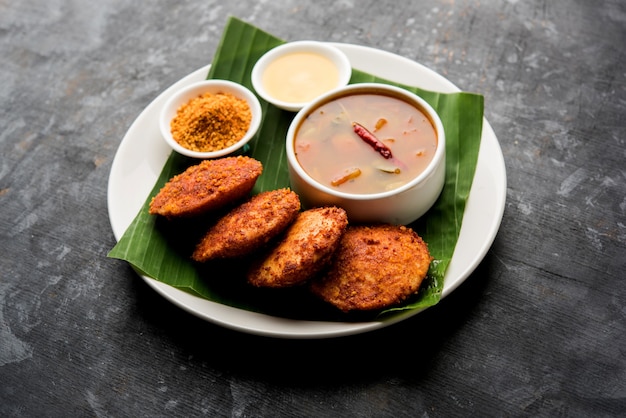 Podi idli is a quick and easy snack made with leftover idly. served with sambar and coconut chutney. selective focus