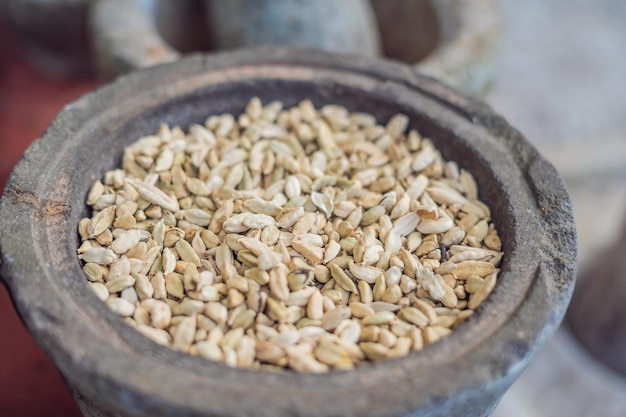 Pods of green cardamom in a large pottery