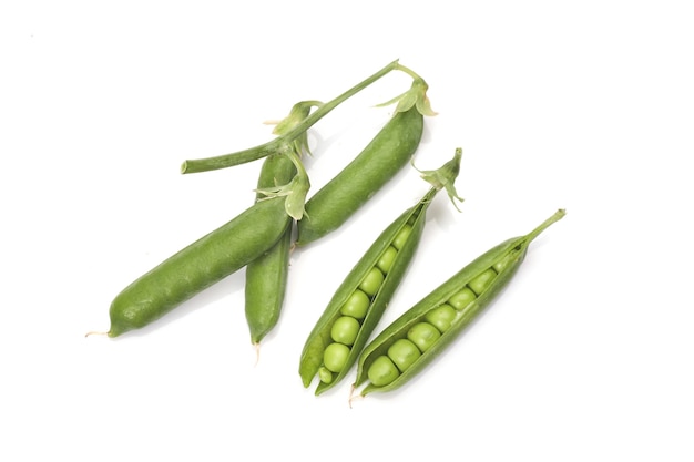 Pods of green peas with leaves isolated on white background