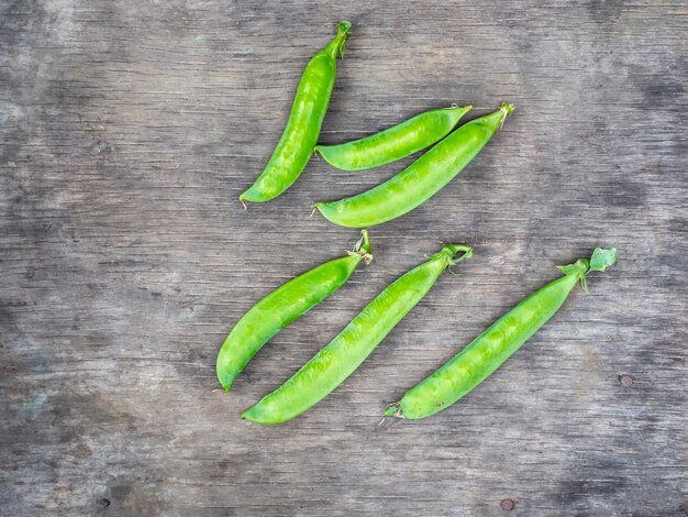 Pods of young green peas on a street table top view