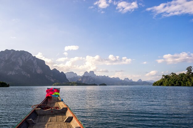 Point of view of Cheow Lan lake from long tail boat among beautiful high mountains and cle