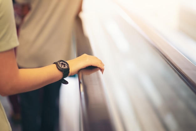 Point of view of a women riding an escalator to the second floor of the mall