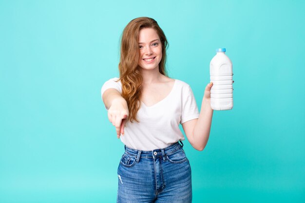 Pointing at camera choosing you and holding a milk bottle