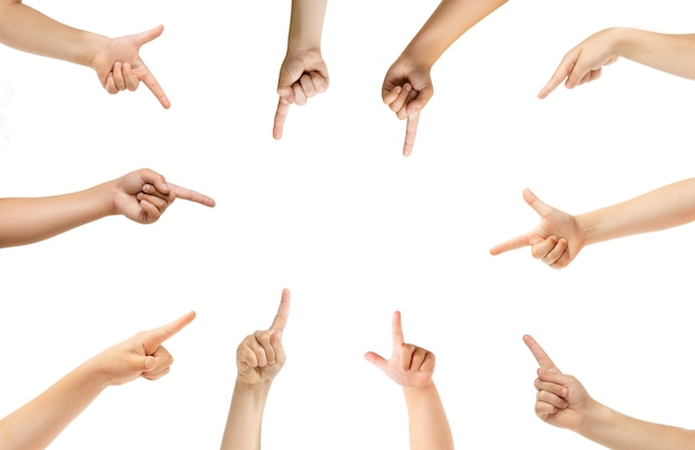 Pointing in center. Kids hands gesturing isolated on white studio background, copyspace for ad. Crowd of kids gesturing. Concept of childhood, education, preschool and school time. Signs and senses.