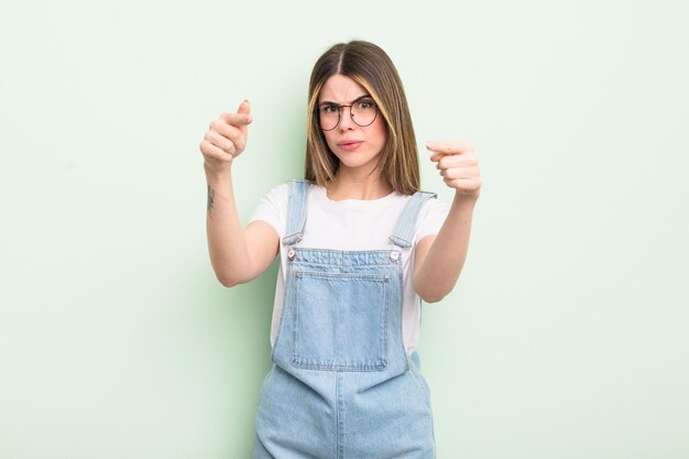 Pointing forward at camera with both fingers and angry expression telling you to do your duty