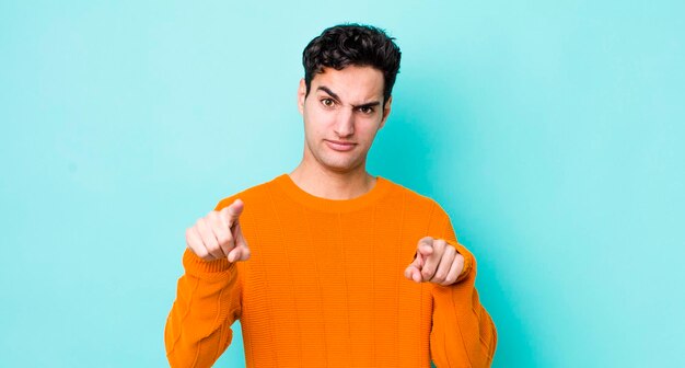 Pointing forward at camera with both fingers and angry expression telling you to do your duty