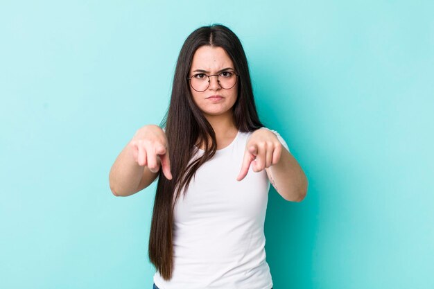 Pointing forward at camera with both fingers and angry expression telling you to do your duty