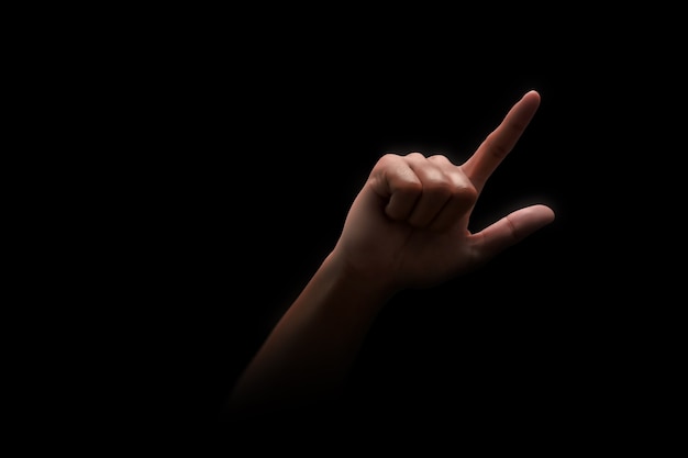 Pointing of index finger hand direction number one gesture sign and showing arm touch or press isolated on black background with choosing concept.