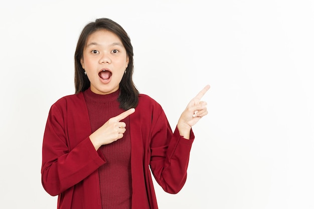 Pointing Product Aside Of Beautiful Asian Woman Wearing Red Shirt Isolated On White Background