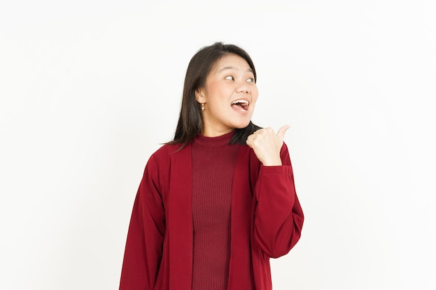 Pointing Product Aside Of Beautiful Asian Woman Wearing Red Shirt Isolated On White Background