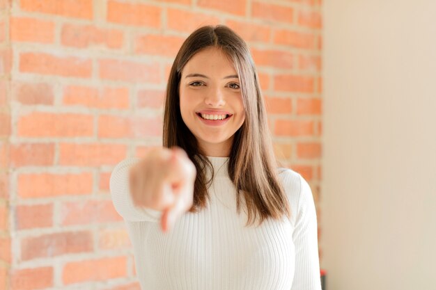 pointing with a satisfied, confident, friendly smile, choosing you