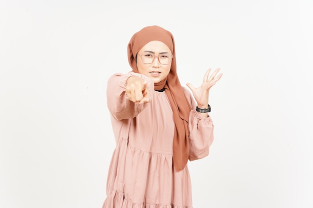 Pointing at you and angry of beautiful asian woman wearing\
hijab isolated on white background