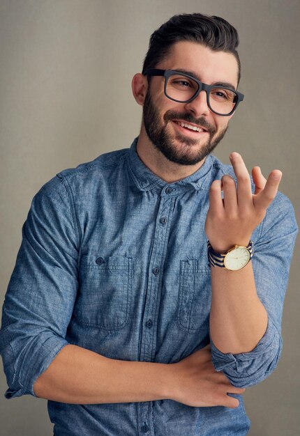 Poised with confidence Studio shot of a handsome young man posing against a grey background