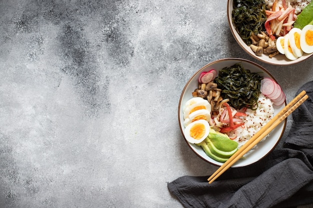 Poke bowl with crab, rice, avocado and egg