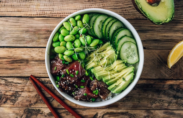 Poke bowl with raw tuna rice avocado edamame beans and cucumber in a bowl Hawaiian ahi poke bowl