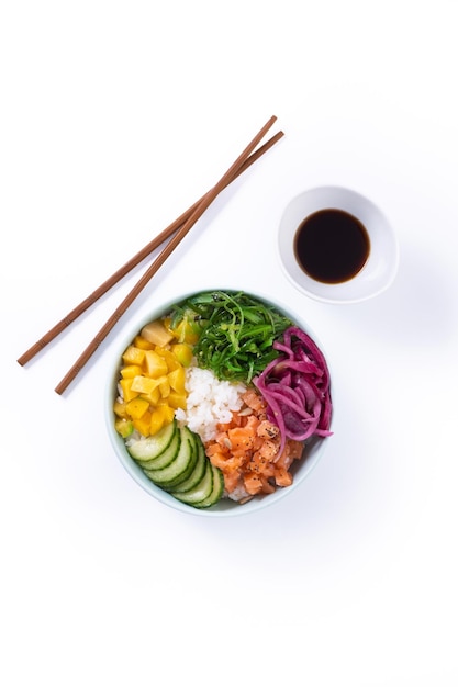 Poke bowl with rice salmoncucumbermangoonionwakame salad poppy seeds ands sunflowers seeds isolated on white background