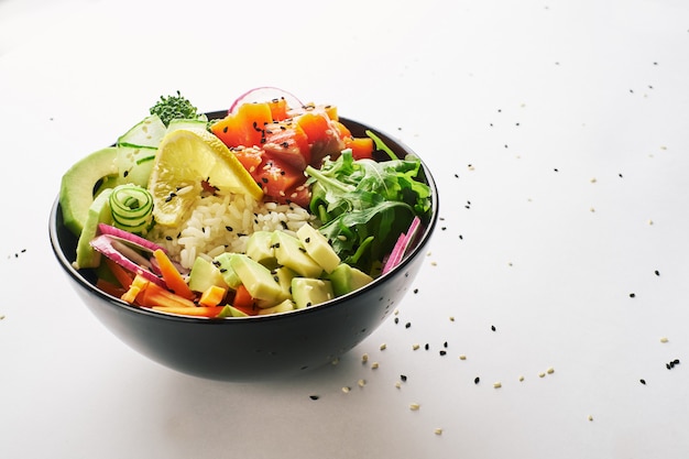 Poke bowl with salmon, avocado isolated over white background.