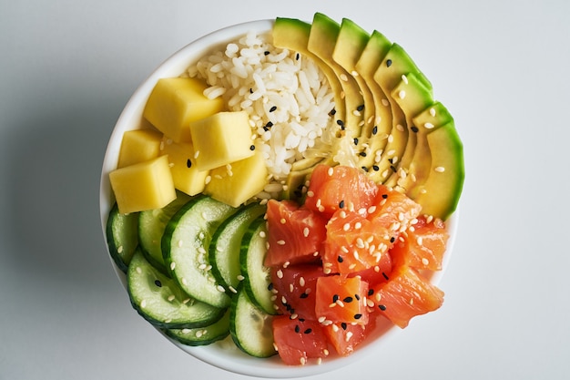 Photo poke bowl with salmon islated on white background. top view