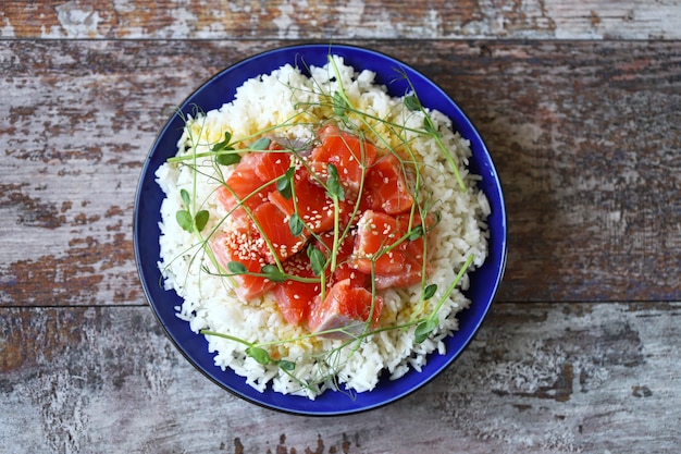  Poke bowl with salmon and microgreens. Healthy food.