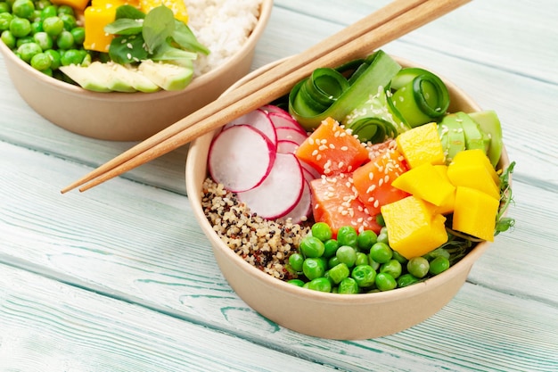 Poke bowls with shrimps salmon avocado and mango