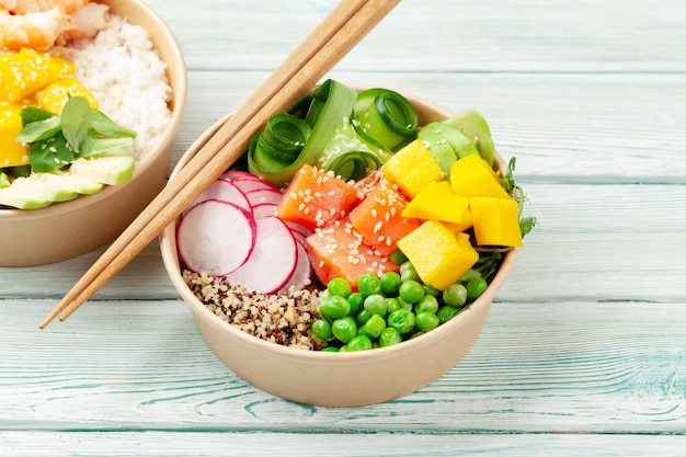 Poke bowls with shrimps salmon avocado and mango