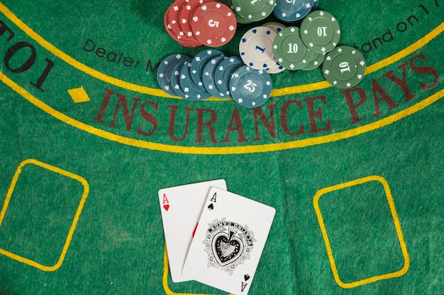 Poker aces with chips on green table