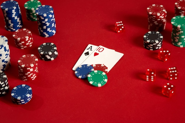 Poker cards and gambling chips on red background. Top view. Copy space. Still life. Flat lay. Cards - Ace and Ten