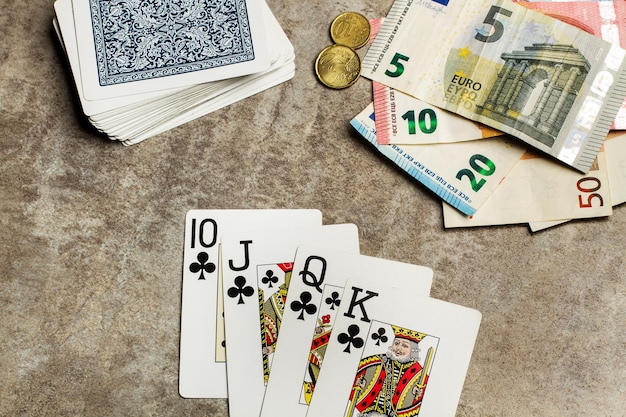 Poker cards and money on a wooden table