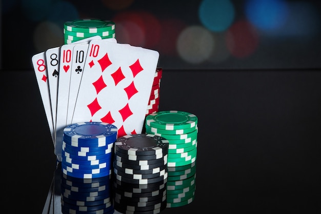 Poker cards with full house or full boat combination. Close-up of playing cards and chips in poker club. Free advertising space