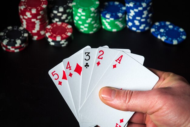 Poker cards with high card combination Close up of gambler hand is holding playing cards