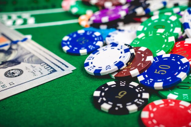 Poker chips and banknotes on table in casino