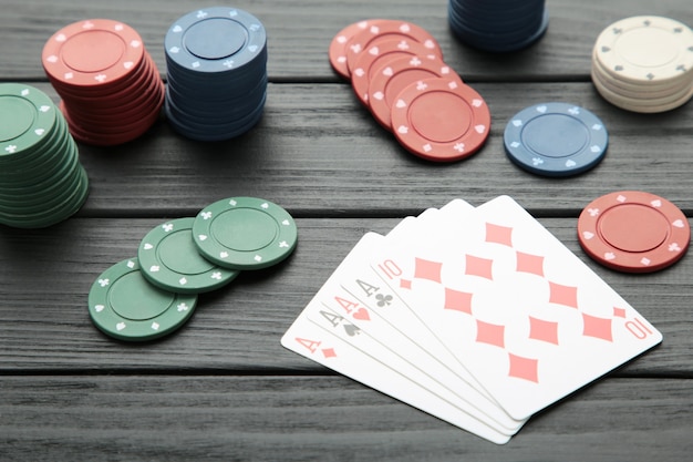 Poker chips on black wooden wall. Casino. Top view