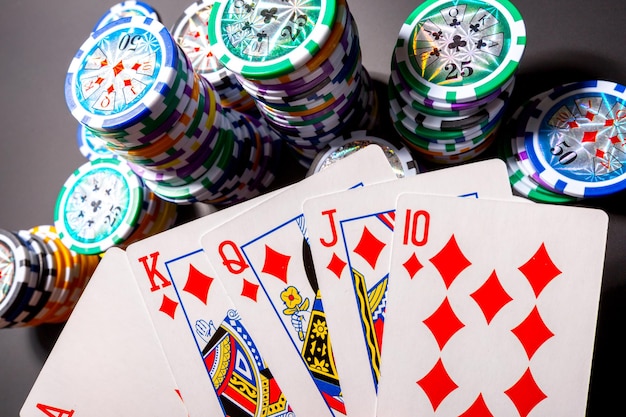 Poker chips and cards on black background