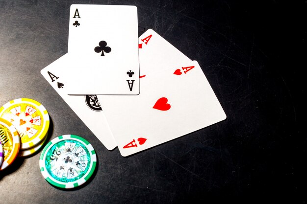 Poker chips and cards on black  